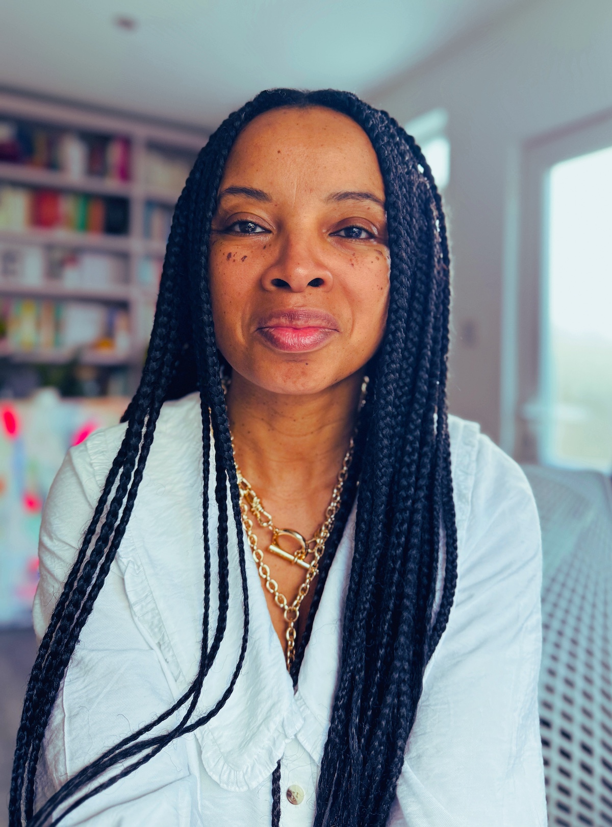 Natalie Lue sitting in her studio in white shirt Natalie Lue sitting in her studio in white shirt